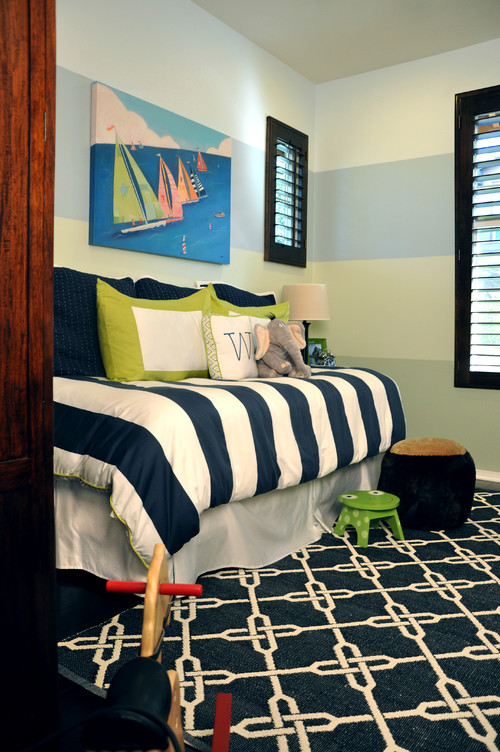 Day Bed With Striped Bedding and Chain Printed Rug Matches Well With Striped Wall Painting and Sailboat Wall Art